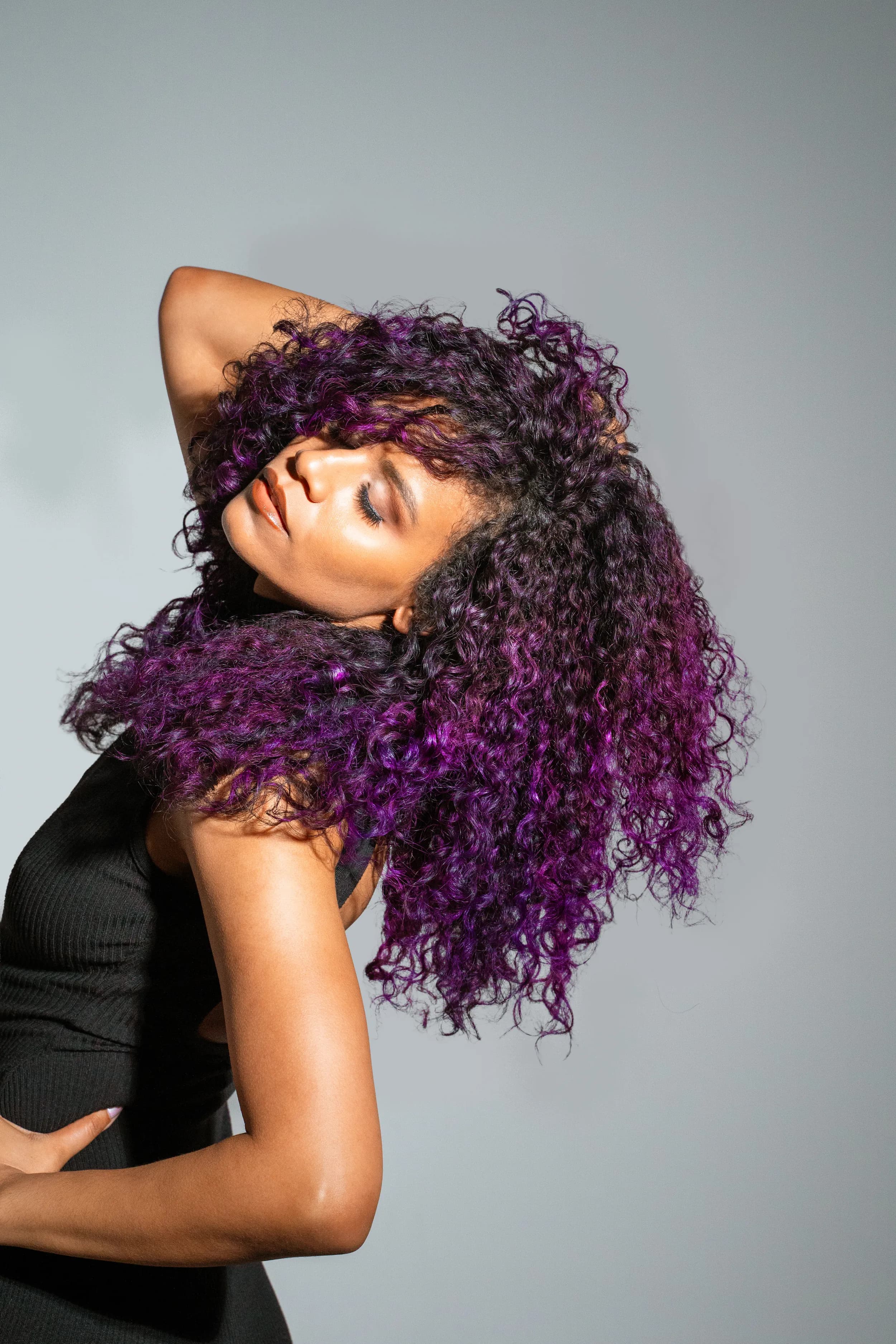 A model with vivid purple curls